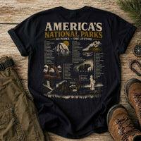 Thumbnail for Black t-shirt with 'America's National Parks' graphic on a wooden surface with hiking gear.