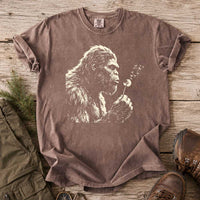 Thumbnail for May include a Espresso Bigfoot blowing a dandelion graphic on a casual T-shirt for men and women with a funny Sasquatch blowing wishes design.