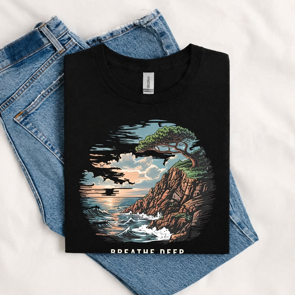 May include a Black Breathe Deep Keep It Simple T-Shirt featuring a scenic coastal landscape with ocean waves, rocky cliffs, a windswept tree, and an inspirational nature graphic.