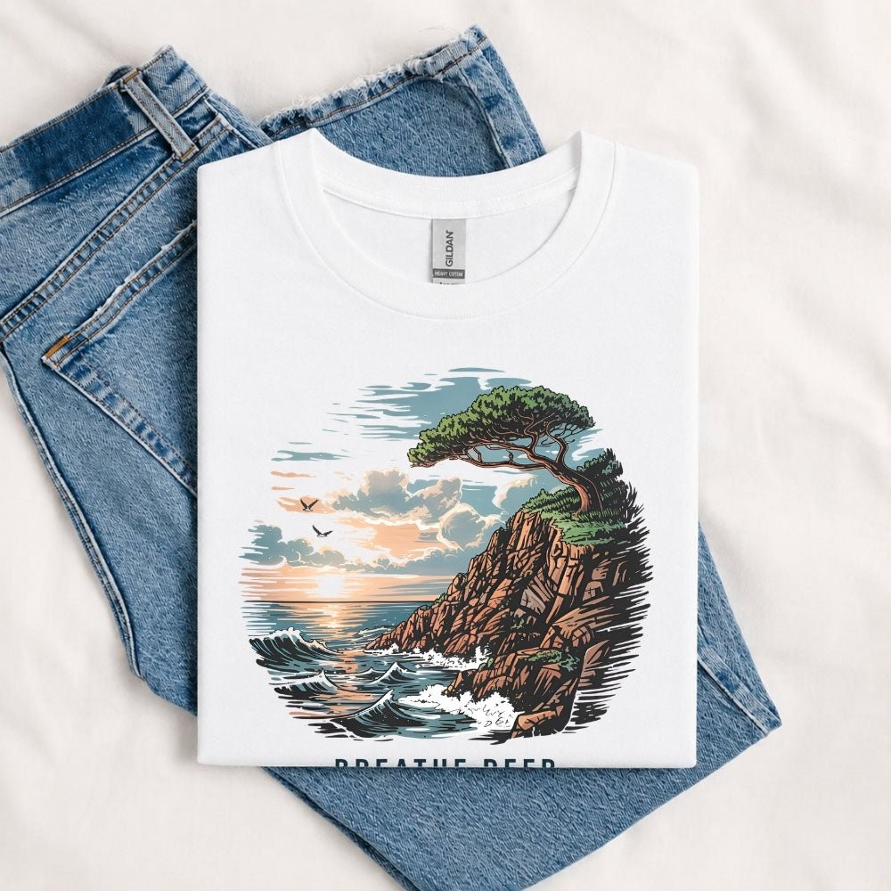 May include a White Breathe Deep Keep It Simple T-Shirt featuring a scenic coastal landscape with ocean waves, rocky cliffs, a windswept tree, and an inspirational nature graphic.