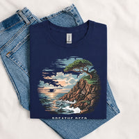 Thumbnail for May include a Navy Breathe Deep Keep It Simple T-Shirt featuring a scenic coastal landscape with ocean waves, rocky cliffs, a windswept tree, and an inspirational nature graphic.