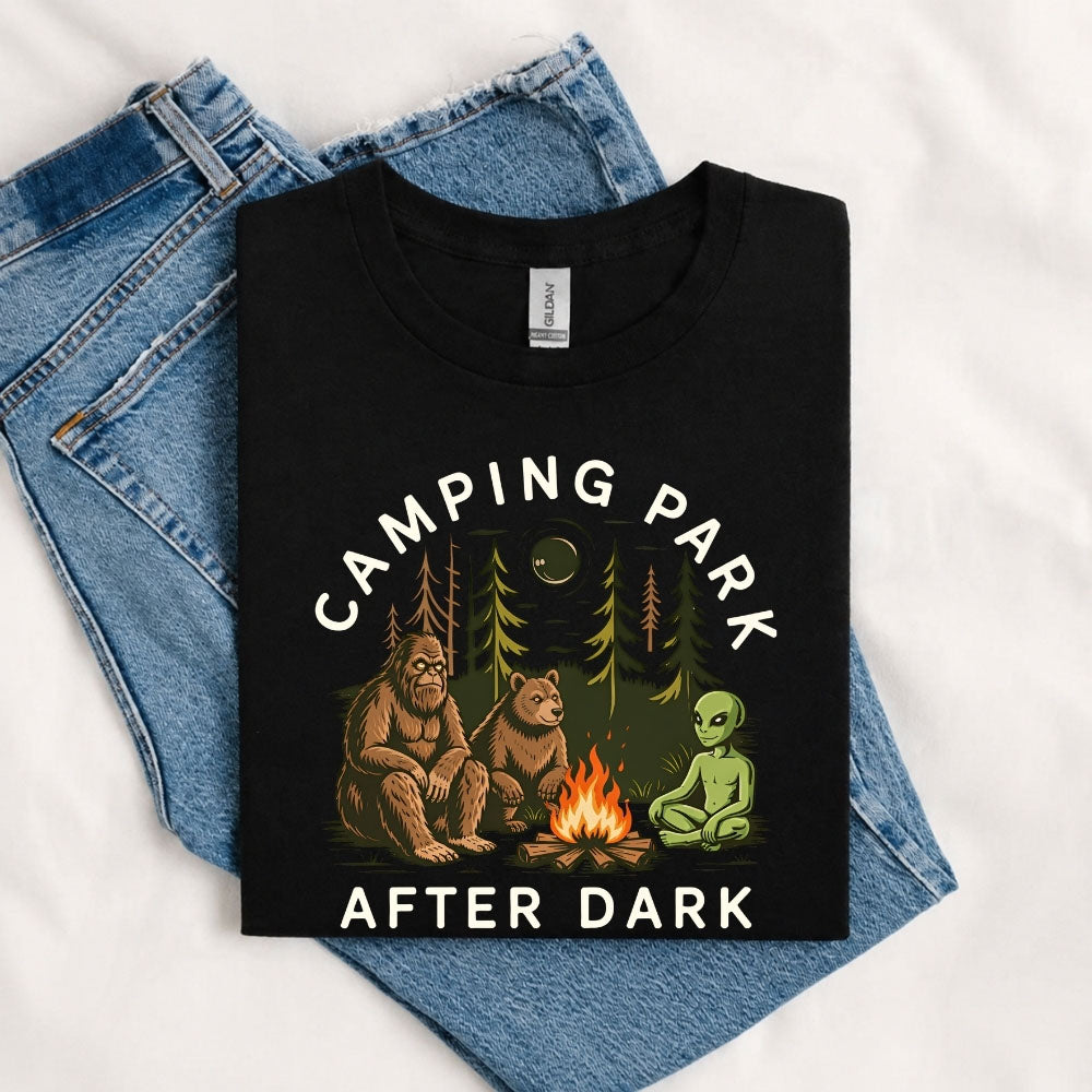 May include a Black Camping Park After Dark T-Shirt featuring alien, Bigfoot, and bear camping graphics with a nighttime forest scene for campers, hikers, and outdoor adventure enthusiasts.