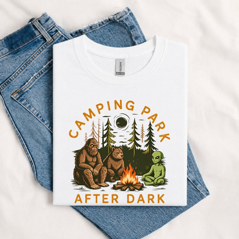 May include a White Camping Park After Dark T-Shirt featuring alien, Bigfoot, and bear camping graphics with a nighttime forest scene for campers, hikers, and outdoor adventure enthusiasts.