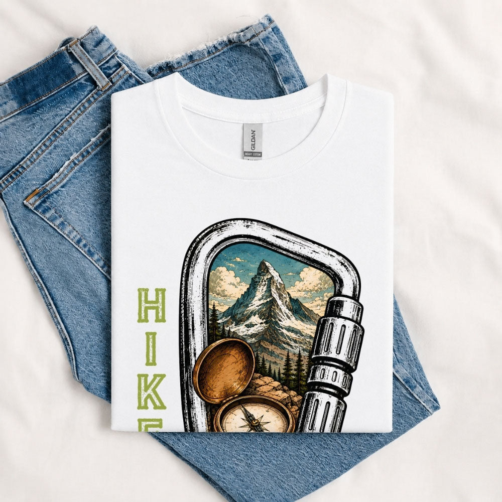 May include a White person wearing the Carabiner Camping T-Shirt featuring a mountain adventure graphic with a carabiner design for hikers and outdoor enthusiasts.