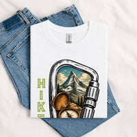 Thumbnail for May include a White person wearing the Carabiner Camping T-Shirt featuring a mountain adventure graphic with a carabiner design for hikers and outdoor enthusiasts.