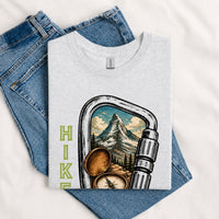 Thumbnail for May include a Sport Grey person wearing the Carabiner Camping T-Shirt featuring a mountain adventure graphic with a carabiner design for hikers and outdoor enthusiasts.