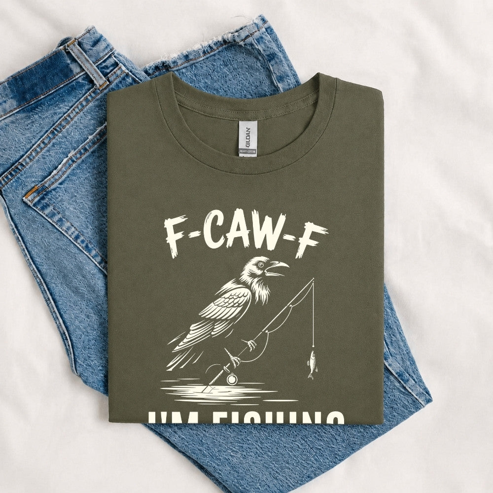 May include a Military Green funny fishing-themed graphic T-shirt featuring the phrase “F-CAW-F I’m Fishing” with an outdoor angling design.