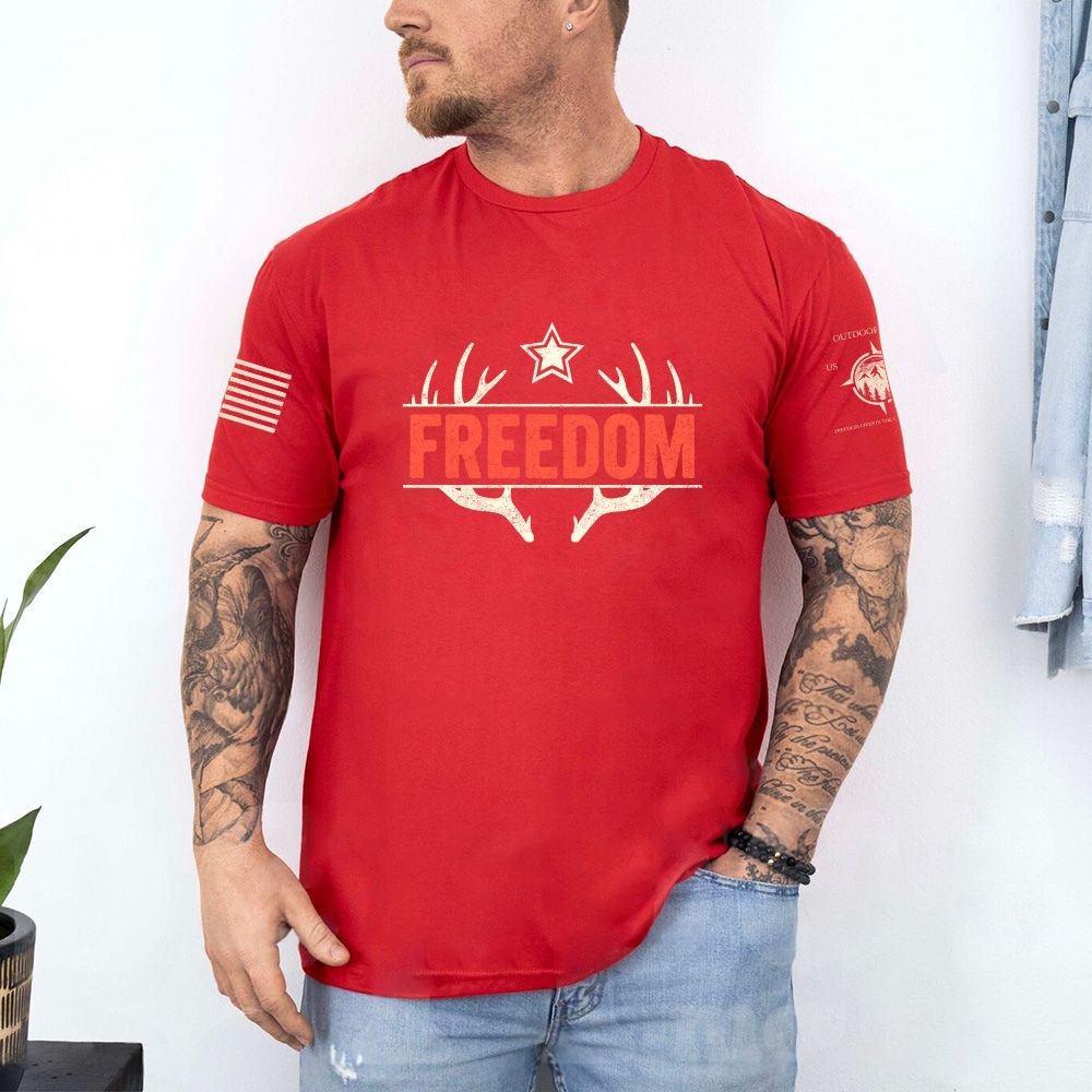 May include person wearing a red Freedom unisex patriotic American liberty t-shirt with bold USA-inspired text design.
