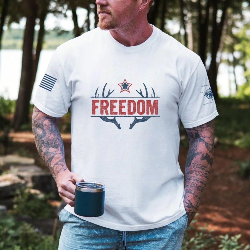 May include person wearing a white Freedom unisex patriotic American liberty t-shirt with bold USA-inspired text design.
