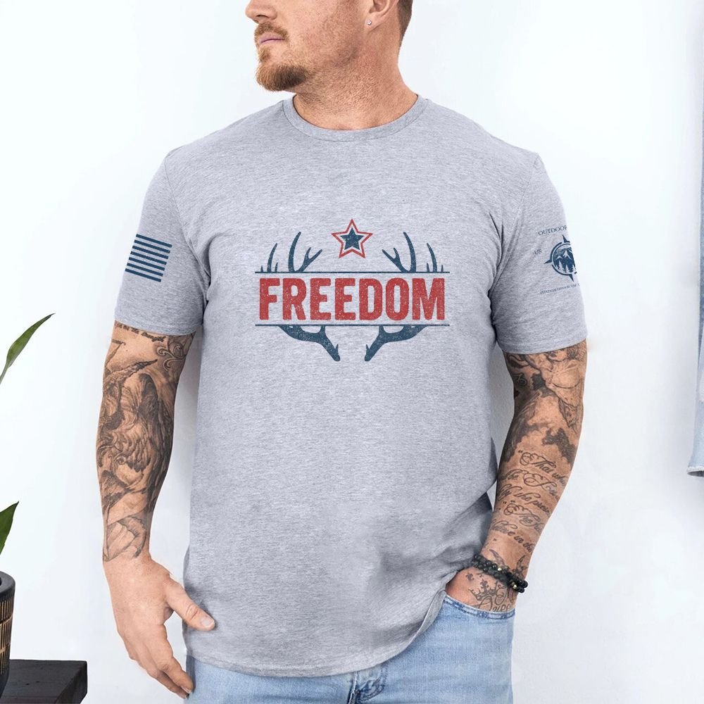 May include person wearing a gray Freedom unisex patriotic American liberty t-shirt with bold USA-inspired text design.
