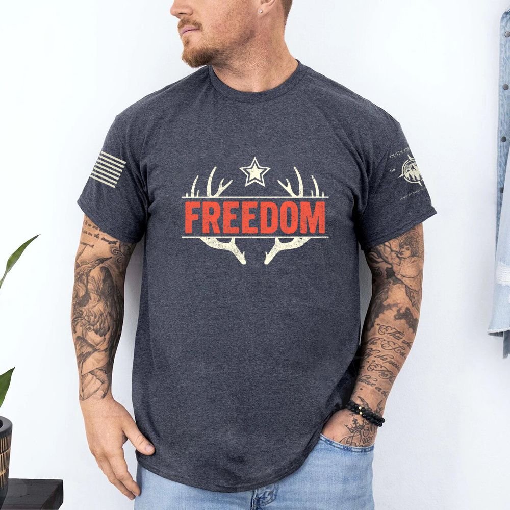 May include person wearing a dark gray Freedom unisex patriotic American liberty t-shirt with bold USA-inspired text design.
