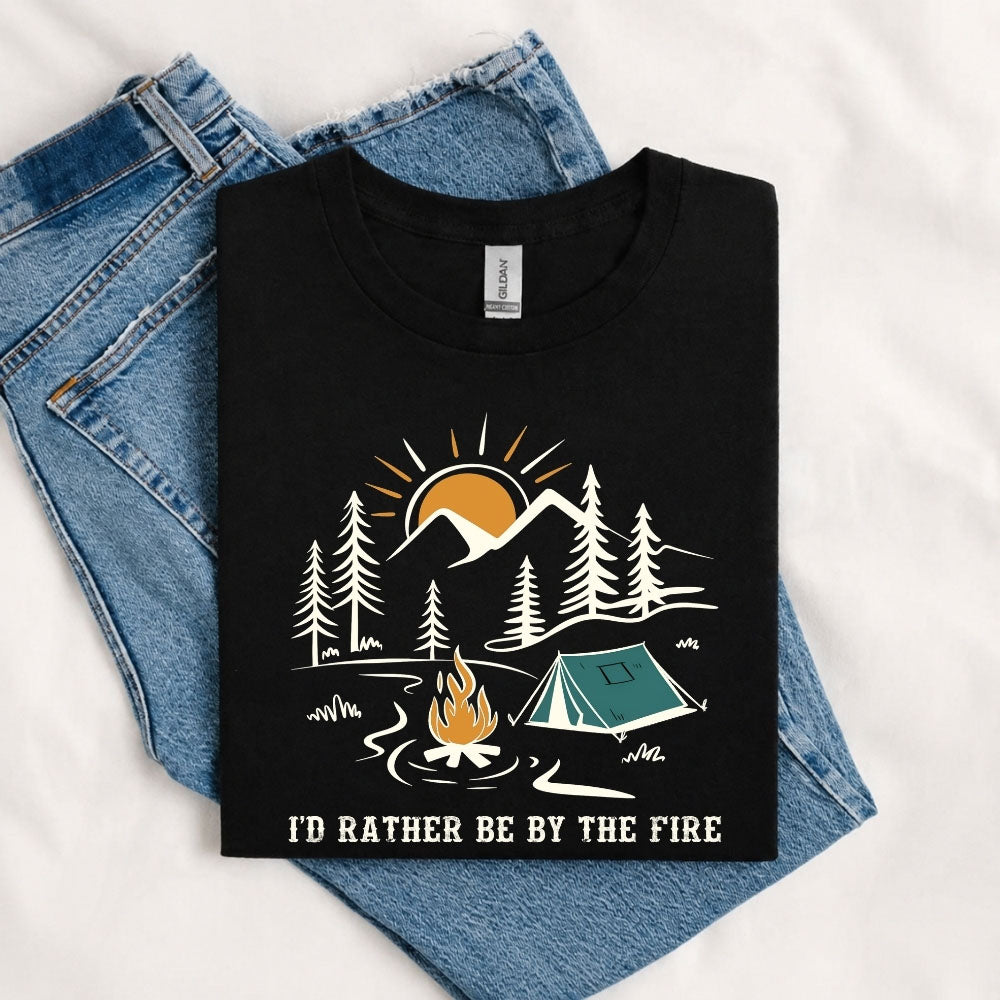 May include a Black I'd Rather Be by the Fire T-Shirt featuring a cozy campfire-inspired graphic for campers, hikers, RV travelers, and outdoor adventure lovers.