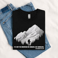 Thumbnail for May include a Black It Is Not the Mountain We Conquer but Ourselves T-Shirt featuring an inspirational mountain quote graphic for hikers, climbers, campers, and mountain lovers.