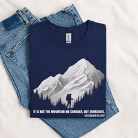 Thumbnail for May include a Navy It Is Not the Mountain We Conquer but Ourselves T-Shirt featuring an inspirational mountain quote graphic for hikers, climbers, campers, and mountain lovers.
