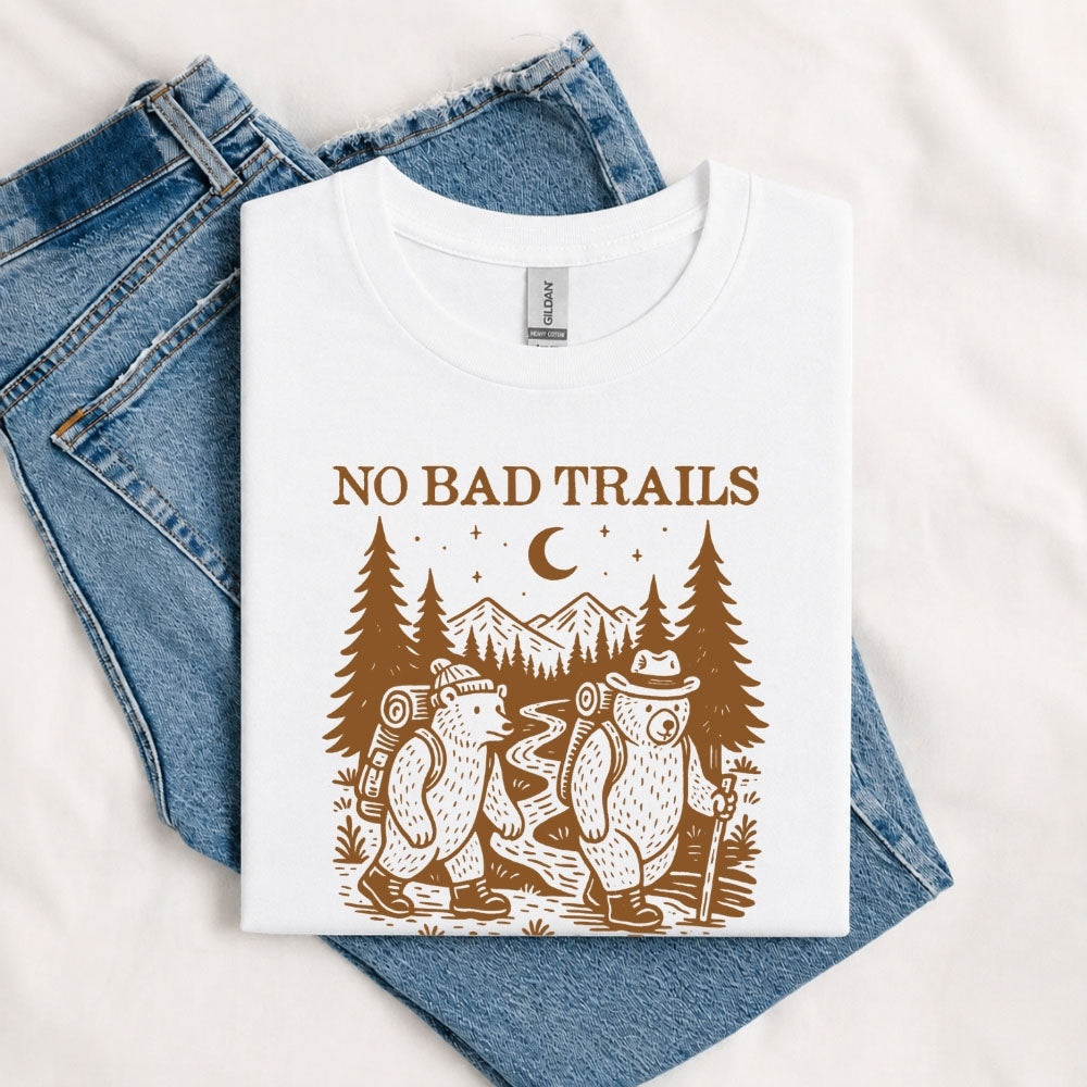 May include a White humorous hiking quote, mountain trail graphic, outdoor-themed design, casual T-shirt, and funny “No Bad Trails Just Bad Knees” message.