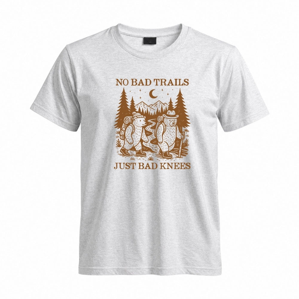 May include a Sport Grey humorous hiking quote, mountain trail graphic, outdoor-themed design, casual T-shirt, and funny “No Bad Trails Just Bad Knees” message.