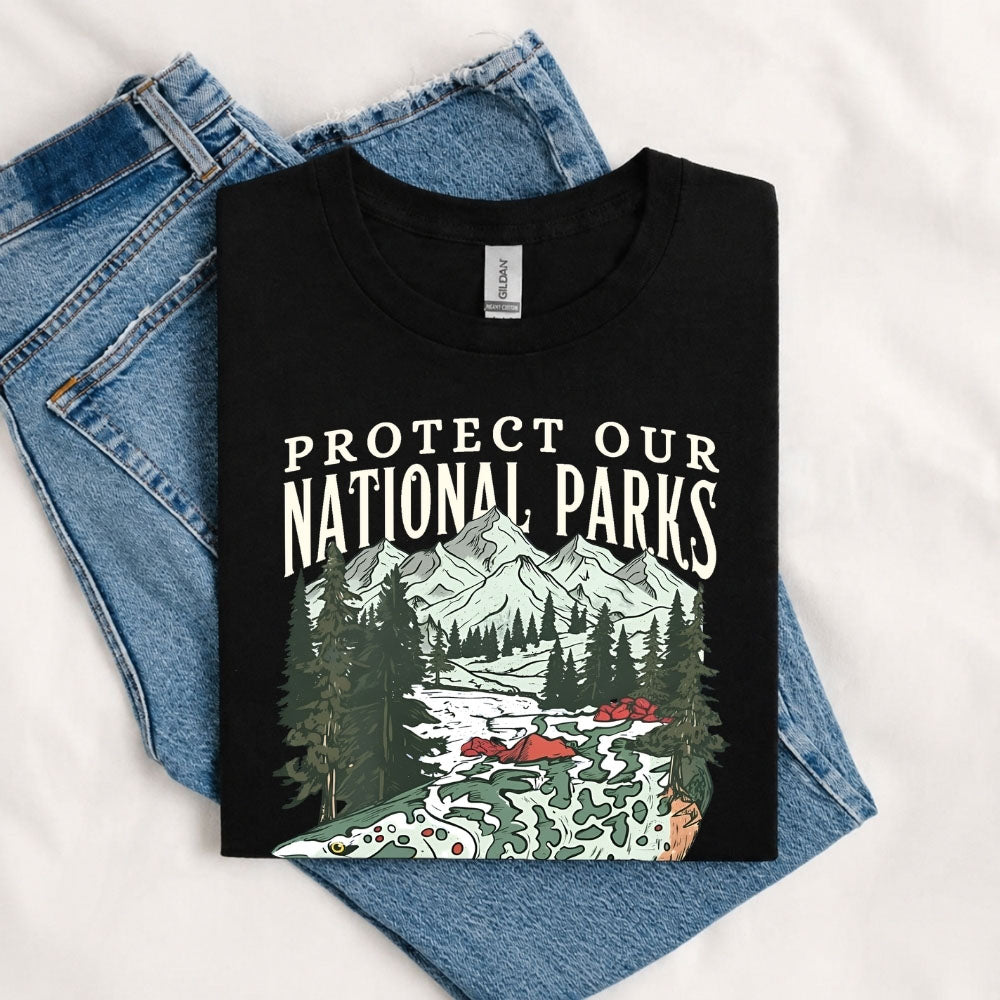 May include a Black Protect Our National Parks Fish X River Graphic T-Shirt featuring a fish silhouette with a scenic river landscape for anglers, hikers, campers, and nature lovers.