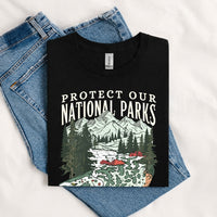 Thumbnail for May include a Black Protect Our National Parks Fish X River Graphic T-Shirt featuring a fish silhouette with a scenic river landscape for anglers, hikers, campers, and nature lovers.