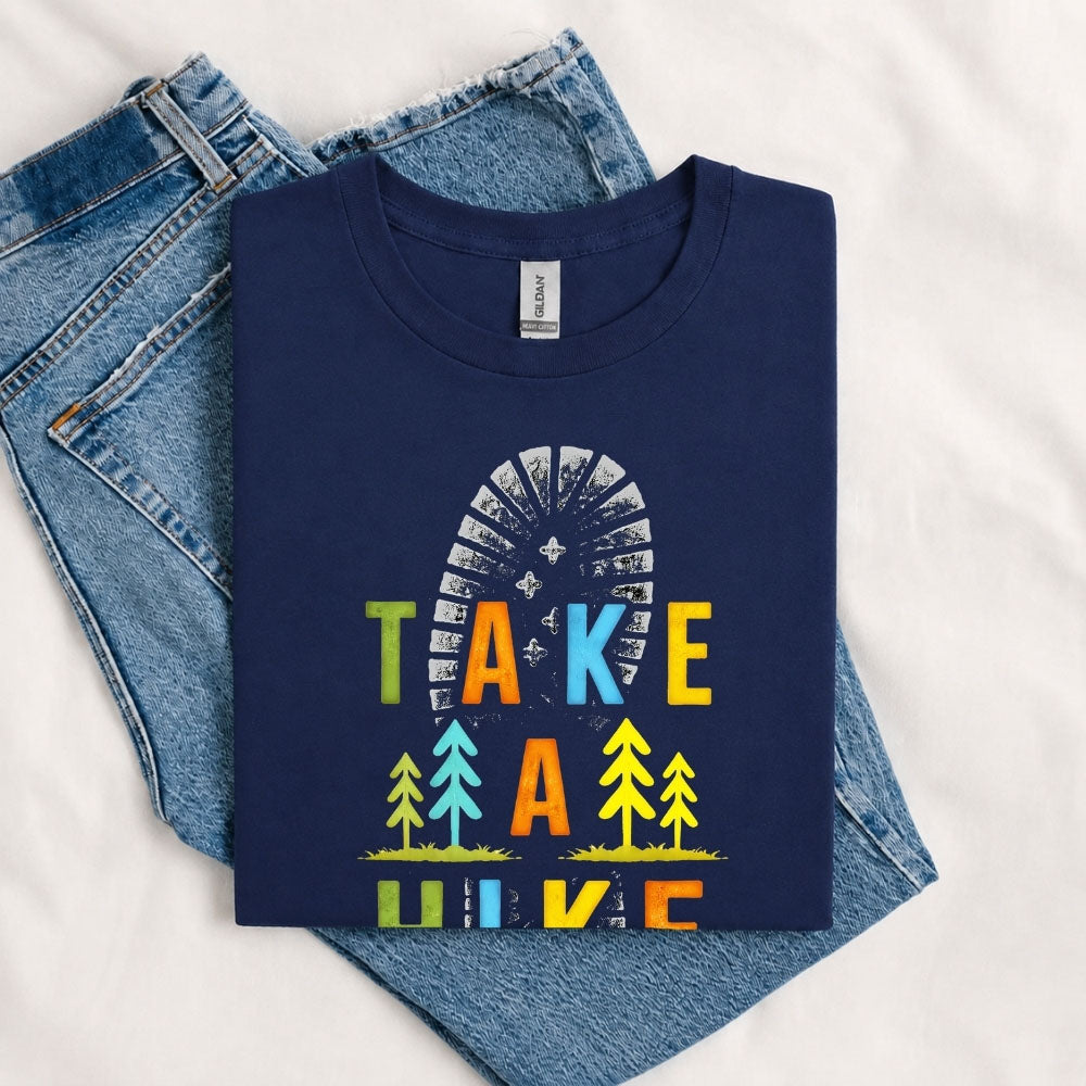 May include a Navy Take A Hike Boot Print T-Shirt featuring a hiking boot print graphic with a funny outdoor quote for hikers, campers, backpackers, and nature lovers.