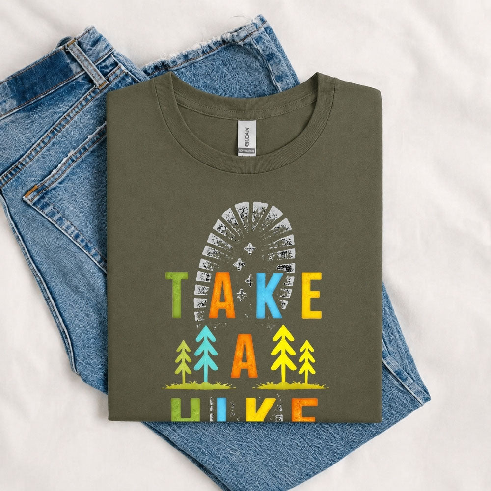 May include a Military Green Take A Hike Boot Print T-Shirt featuring a hiking boot print graphic with a funny outdoor quote for hikers, campers, backpackers, and nature lovers.