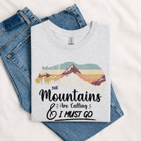 Thumbnail for May include a Sport Grey The Mountains Are Calling and I Must Go T-Shirt featuring an inspirational mountain graphic for hikers, campers, backpackers, and outdoor adventure lovers.