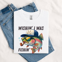 Thumbnail for May include a White Wishin' I Was Fishin' T-Shirt featuring a fishing-inspired graphic for anglers, boaters, lake lovers, and outdoor enthusiasts.